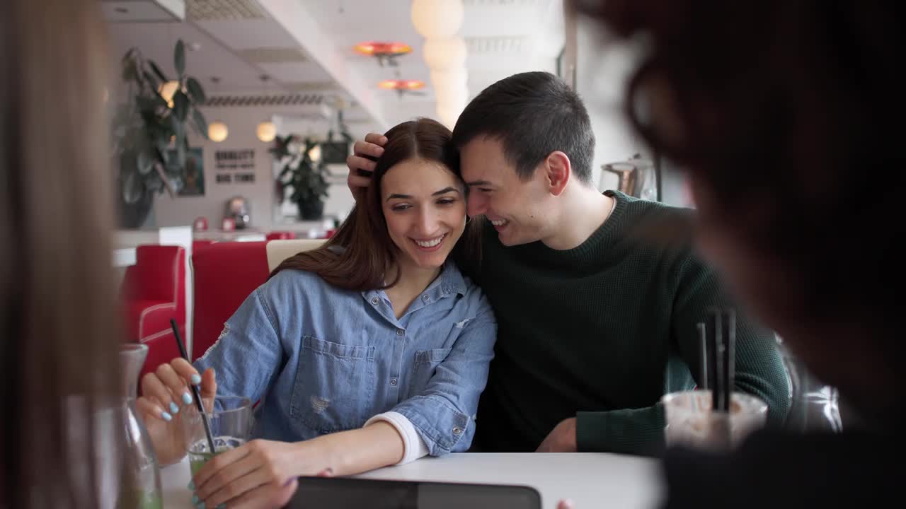 年轻情侣，在复古快餐店享受四人约会视频下载
