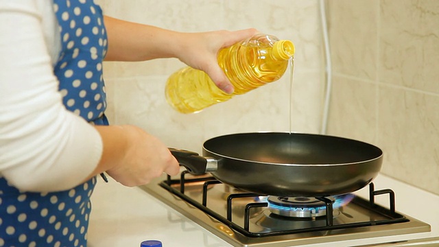 食物准备-将油倒入煎锅视频素材