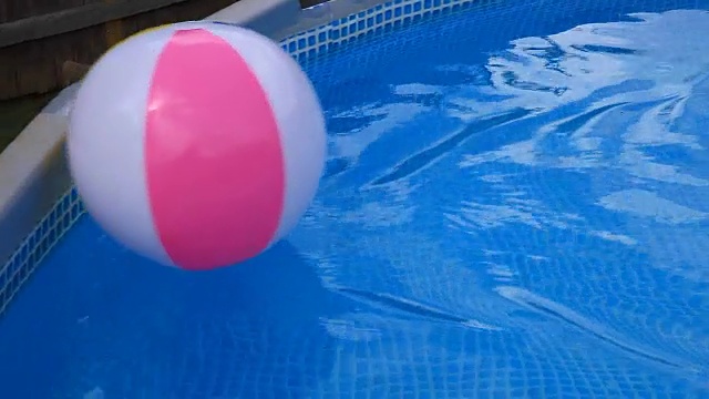 沙滩球漂浮在游泳池风移动视频素材