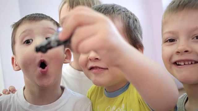 幼儿园里，孩子们开心地看着镜头。真正的情感视频下载