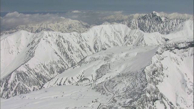在日本，厚厚的积雪覆盖着蜿蜒的山路。视频素材