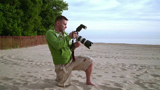 摄影师在海滩上拍照。摄影师的工作视频下载