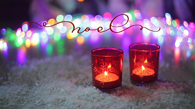 用蜡烛和彩灯在圣诞装饰背景上写下一个古老的词。书法和文字繁盛的元素。圣诞假期视频素材