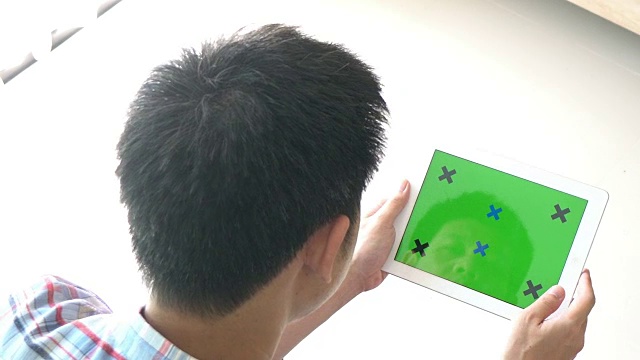 一个人在玩绿色屏幕的数字平板电脑视频下载