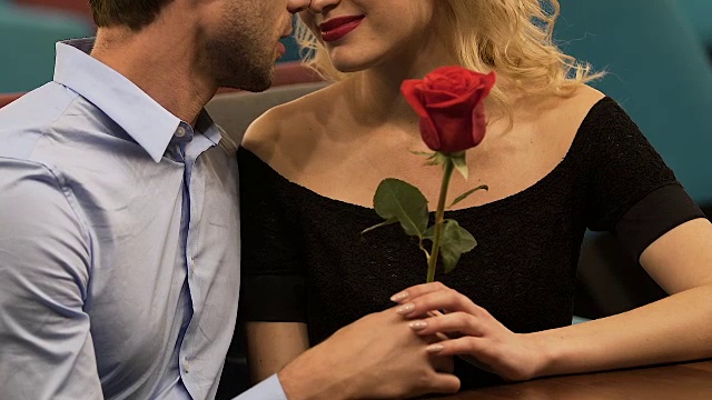 一对情侣坐在餐厅聊天，中间是玫瑰，浪漫的约会视频素材