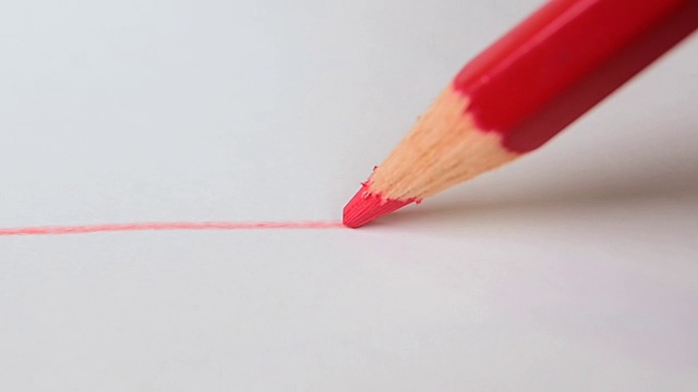 用红铅笔在白画纸上画红线。艺术的概念。视频下载