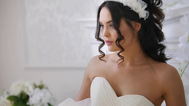 迷人的黑发新娘在时尚婚纱与专业化妆视频素材