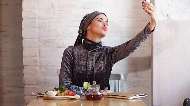 穆斯林女商人在咖啡馆用手机工作视频素材