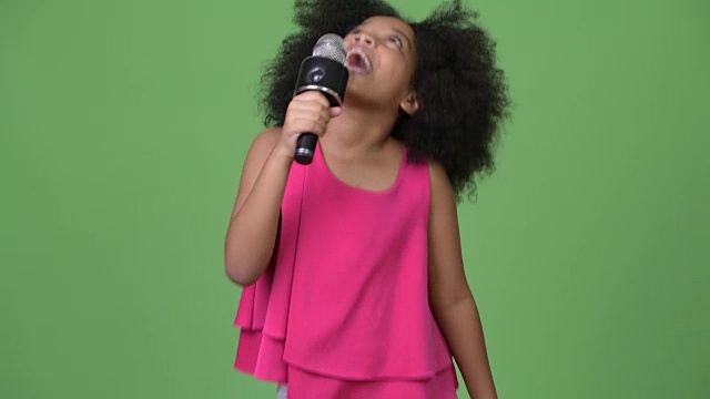 年轻可爱的非洲女孩与非洲发式愉快地唱歌视频下载