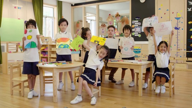 幼儿园外教和孩子们在教室绘画视频下载