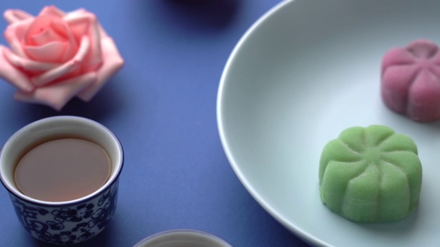 深蓝色背景上的水果月饼和旁边的茶壶视频素材