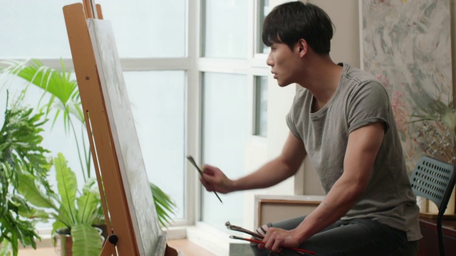 年轻男子在家画画视频素材