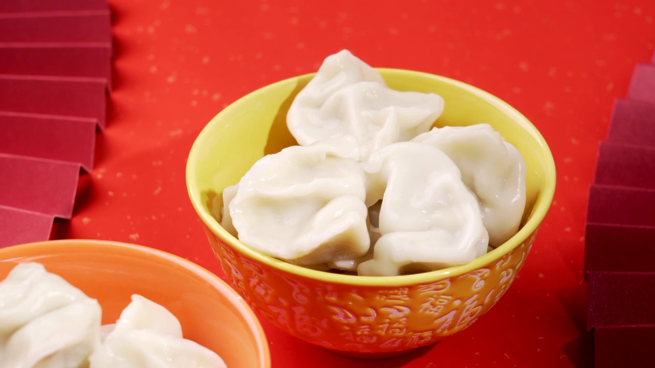 中华传统美食红色富贵喜庆金闪闪背景福字碗上的饺子视频素材