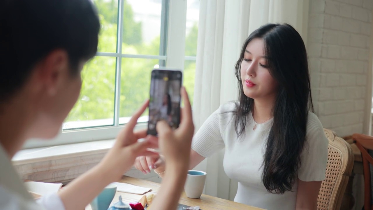 女人用手机给女朋友拍照视频素材