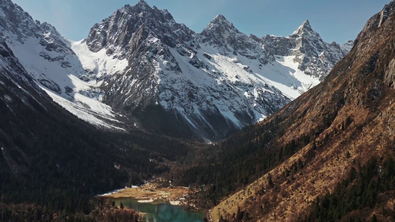 航拍雪山下的森林峡谷视频素材
