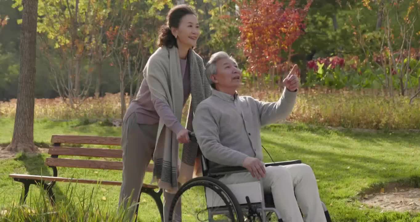 老人推着坐轮椅的老伴逛公园视频素材