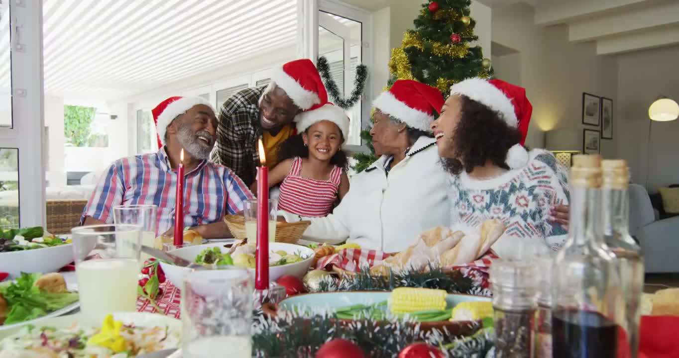快乐的非裔美国人多代家庭戴着圣诞帽，拍摄节日照片视频下载