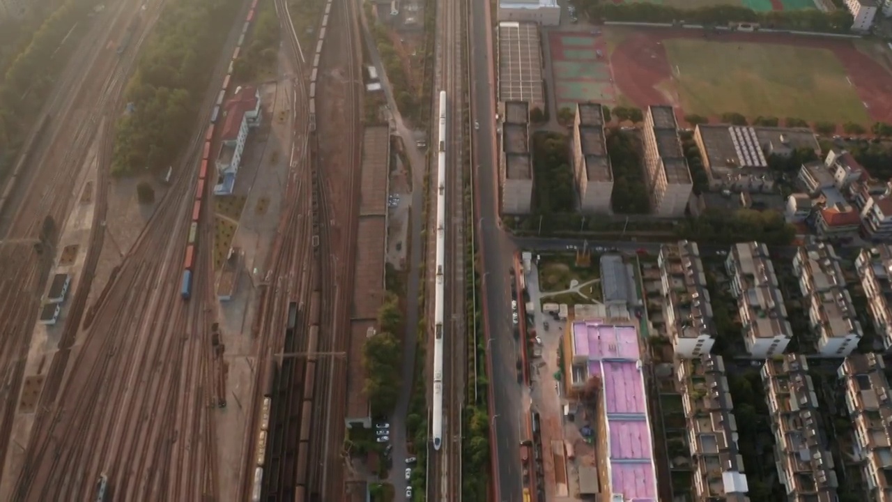 高视角航拍高铁高速动车和谐号列车经过货运火车站视频素材