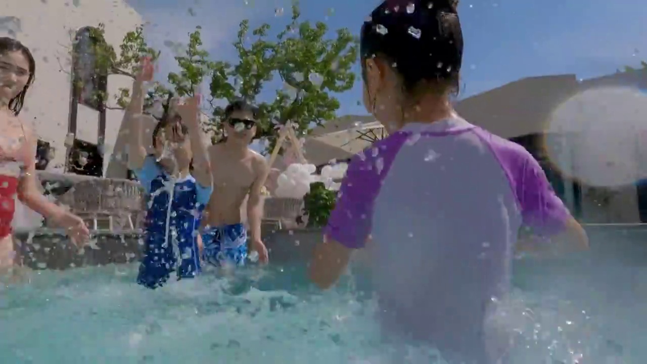 快乐的一家四口在泳池里戏水视频素材