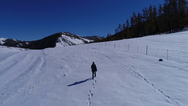 一个男人在雪地行走视频素材