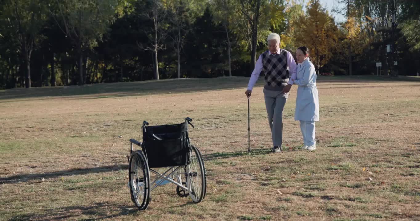 年轻护工搀扶老年人散步视频素材