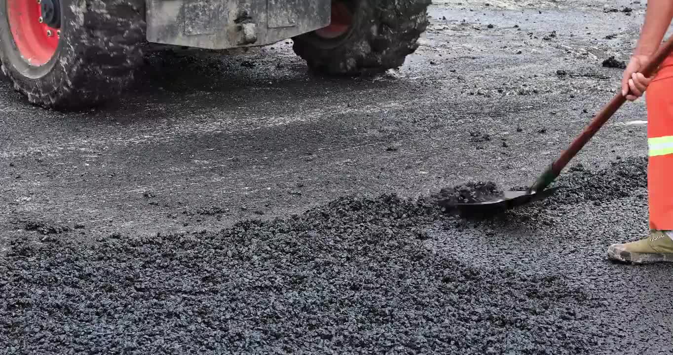 公路工人正在铺设新的沥青道路视频下载