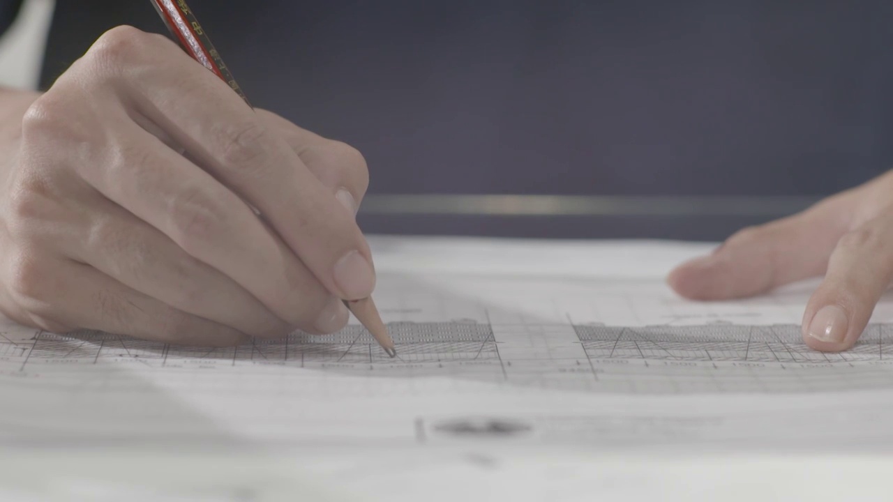 设计师铺图纸画图专注建筑设计房地产素材视频下载