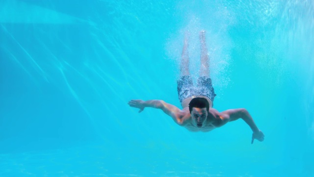 健康人在游泳池里慢动作游泳视频素材