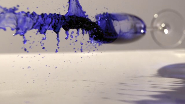 慢镜头中蓝色墨水的跌落和溢出视频素材
