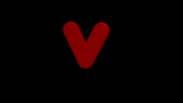 在慢镜头中，字母v在黑色背景上聚焦视频下载
