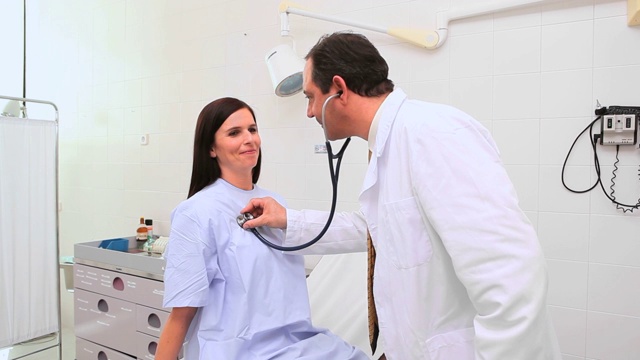 微笑的医生在检查室听诊一个女人视频素材