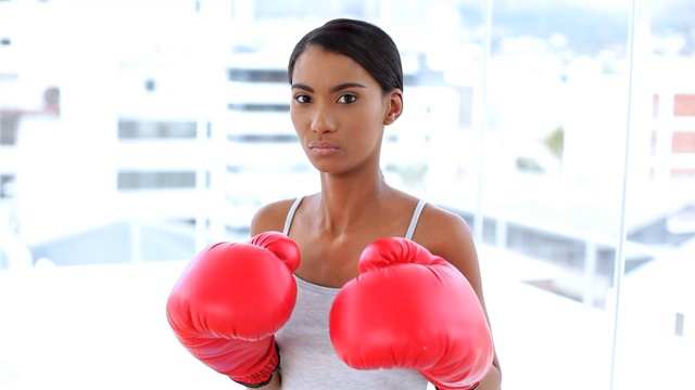 女人穿着运动服戴着拳击手套打拳特写视频下载
