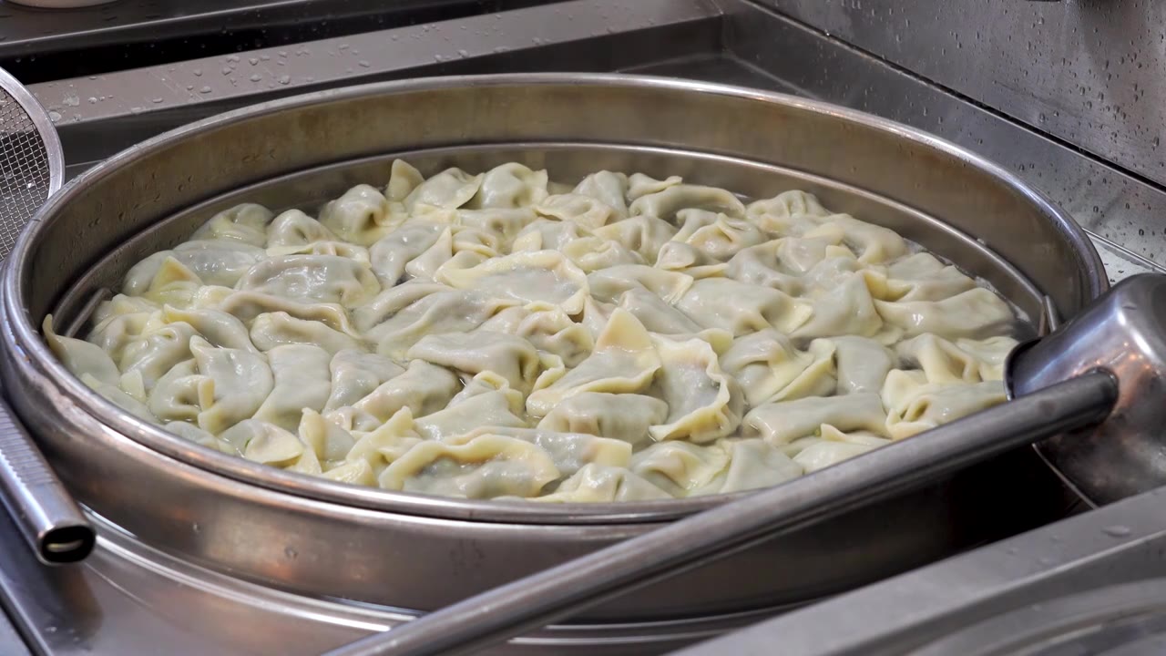 锅中水煮的热气腾腾的饺子视频下载