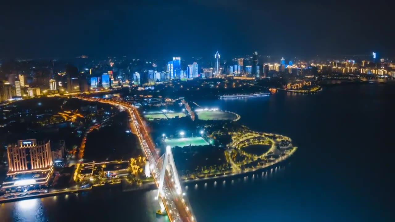 中国海南海口海甸河世纪大桥和国贸CBD俯瞰航拍夜景延时摄影视频下载