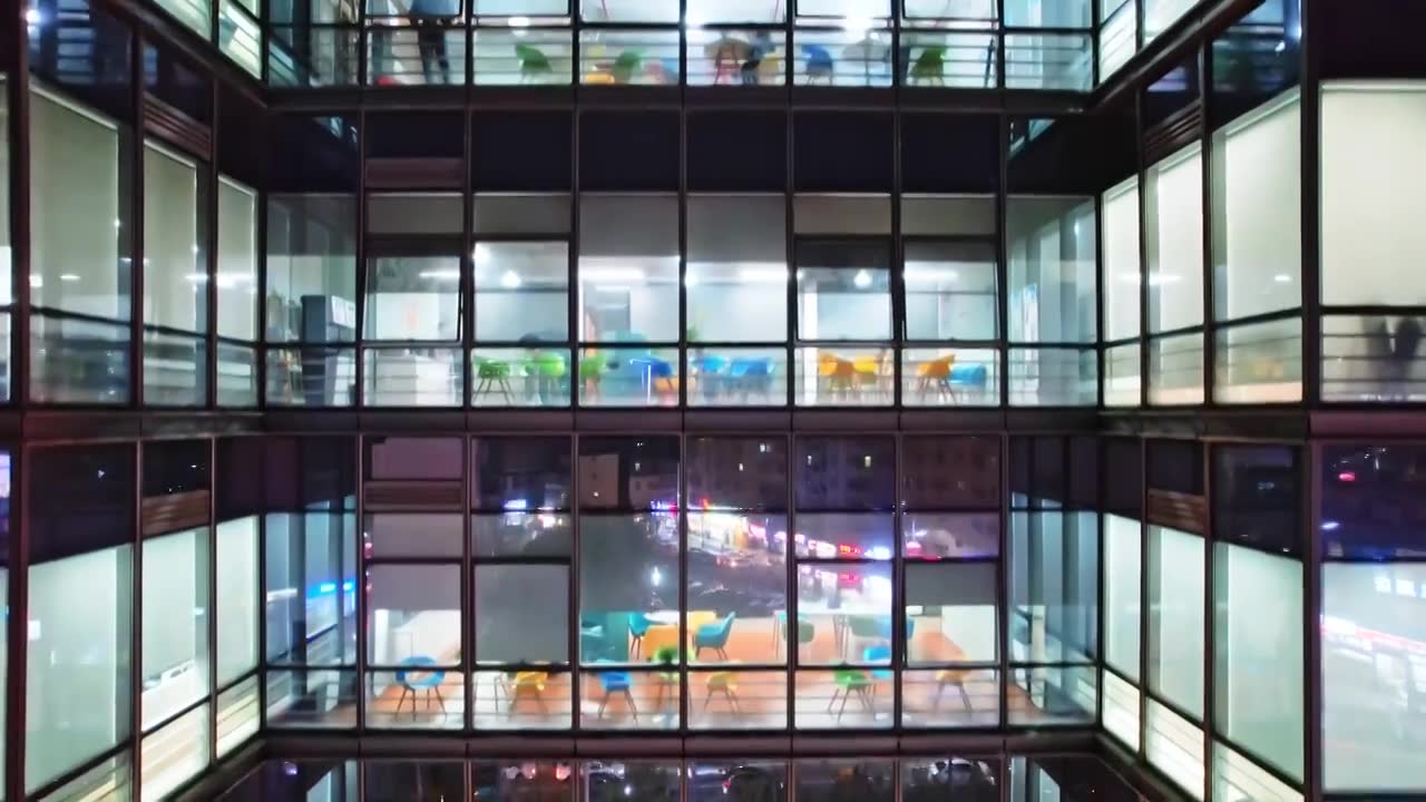 航拍深圳市区熬夜办公的写字楼办公大楼夜景视频下载