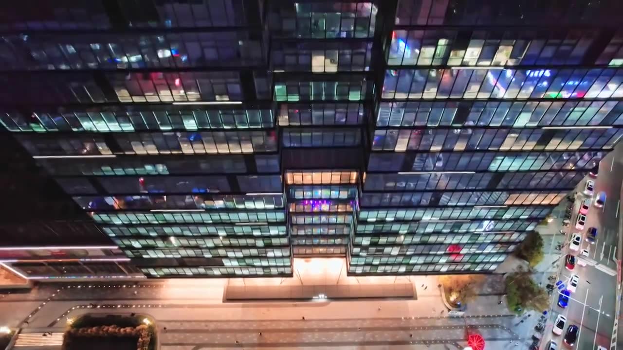 航拍深圳市区熬夜办公的写字楼办公大楼夜景视频下载