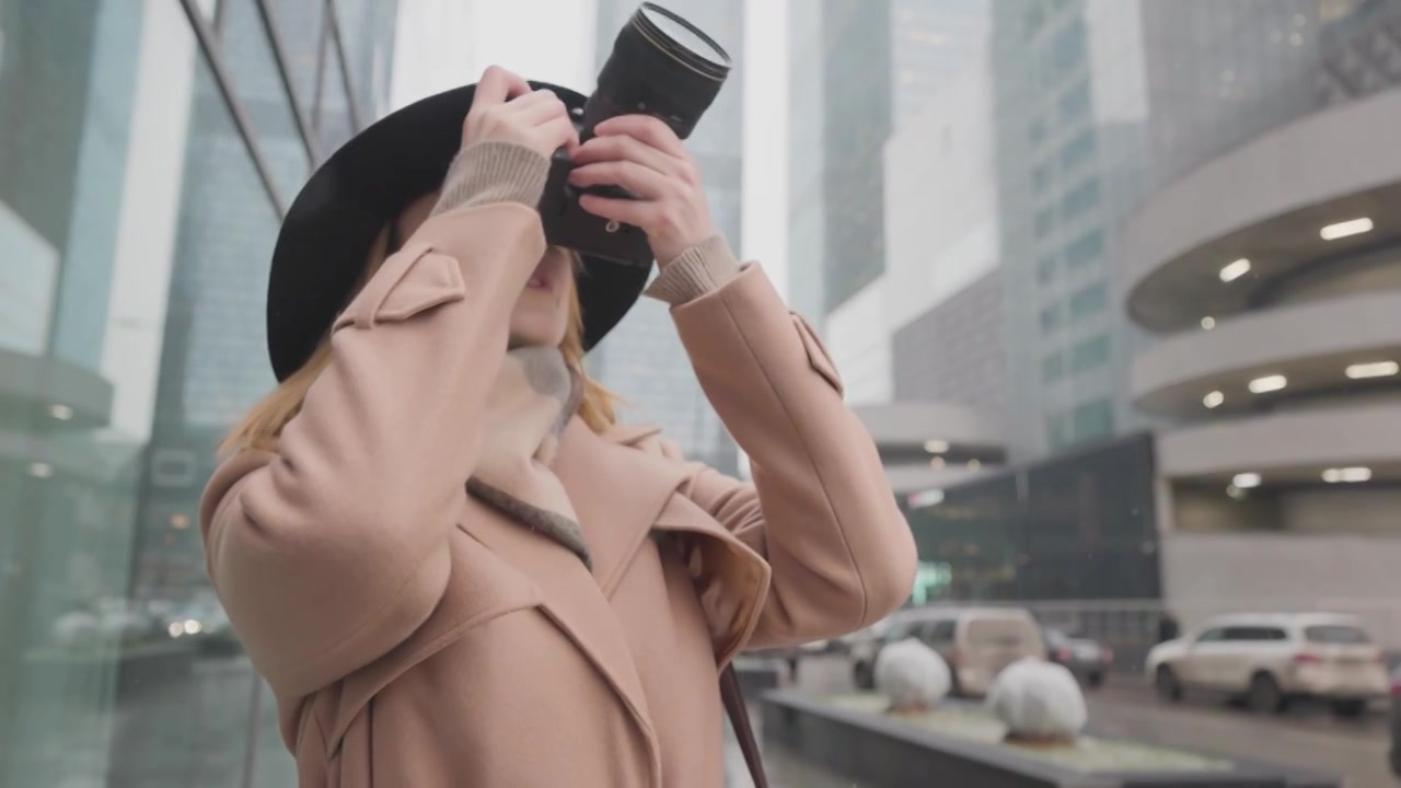 美女拍城市冬季风景。行动。时尚女性拍摄都市视频下载