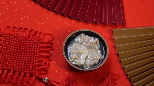 大红色背景上的碗，碗里的饺子视频素材