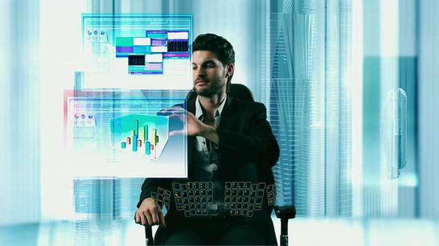 在一个未来主义风格的办公室里，CGI MS Man坐在3D屏幕前排列图表窗口视频素材