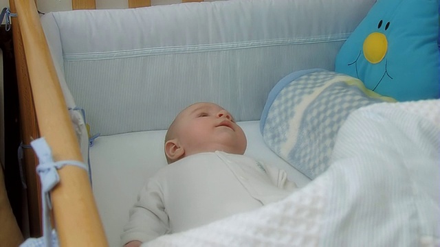 婴儿躺在婴儿床里视频下载
