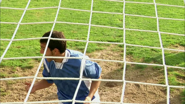 侧视图足球运动员在角球前的冲撞/球员头球进入球门视频下载