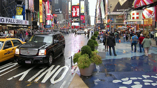 行人走在繁忙街道旁的时代广场人行道上，纽约，美国视频素材