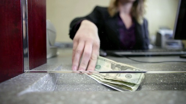 银行出纳员在数银行里的钱视频素材