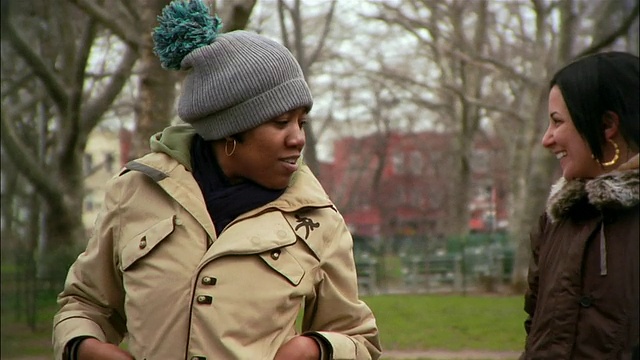 在美国纽约布鲁克林的公园/威廉斯堡，年轻女性在街上互相握手视频素材
