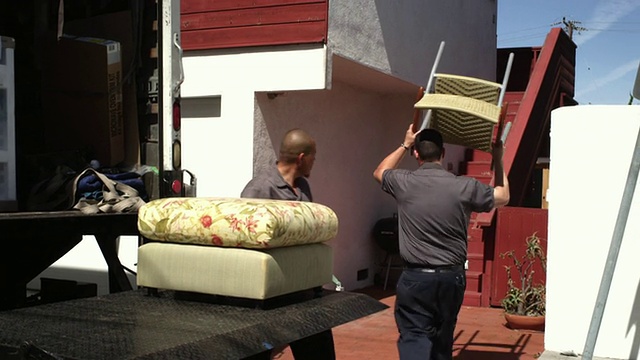 美国加州曼哈顿海滩，两名男性搬运家具和装载卡车视频下载