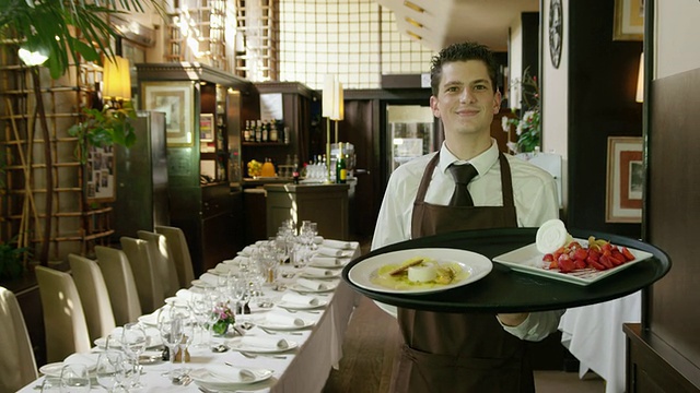 DS餐厅服务员端着盘子跟在摄像机后面看着摄像机视频下载