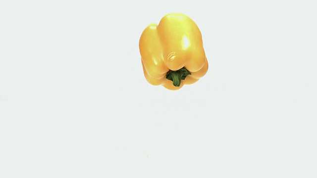 白色背景下黄色的辣椒落在地板上/法国诺曼底的Vieux Pont视频素材