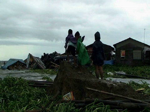 孩子们看着洪水进入棚户区，宽镜头，菲律宾，2009年台风美利奈视频素材