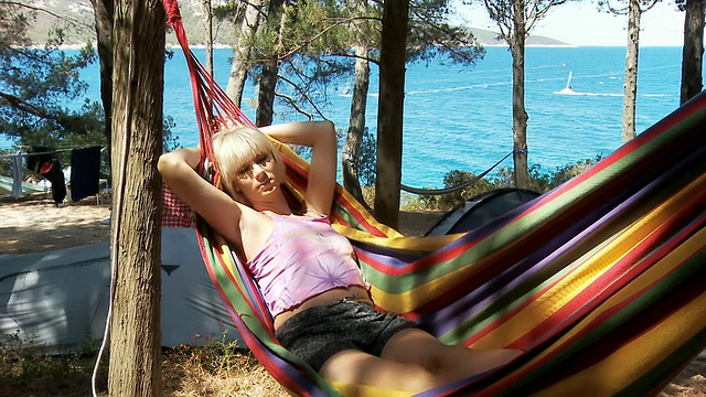 HD多莉:在沙滩上的吊床上放松的女人视频素材