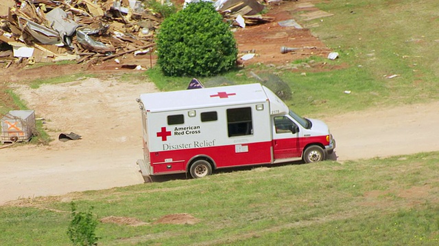 美国俄克拉何马州伍德沃德龙卷风路径上，红十字救援卡车坐在被摧毁的建筑物旁视频下载